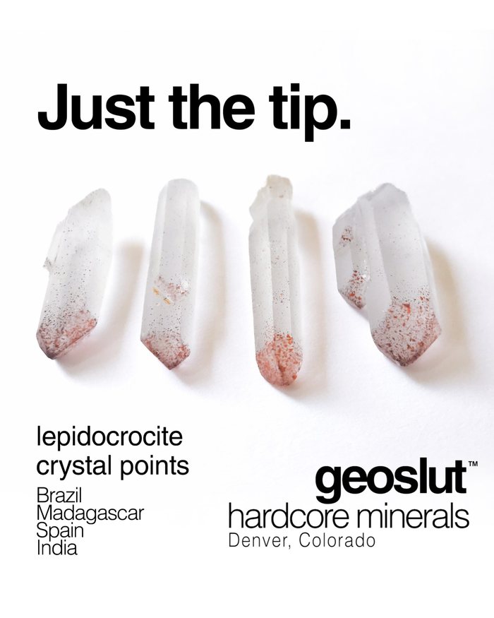 geoslut poster: Just the tip. Four quartz points with red lepidocrocite flecks gathered at one end